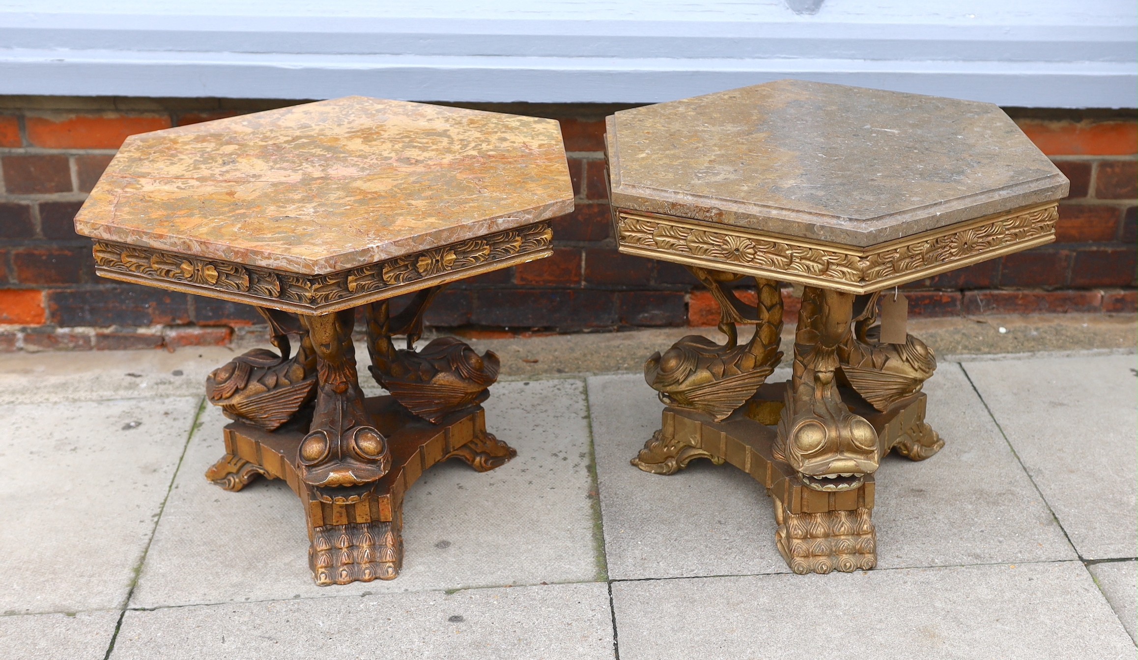 A near pair of 1960’s Italian carved giltwood occasional tables, with hexagonal marble tops and stylised dolphin underframes, height 48cm. width 66cm